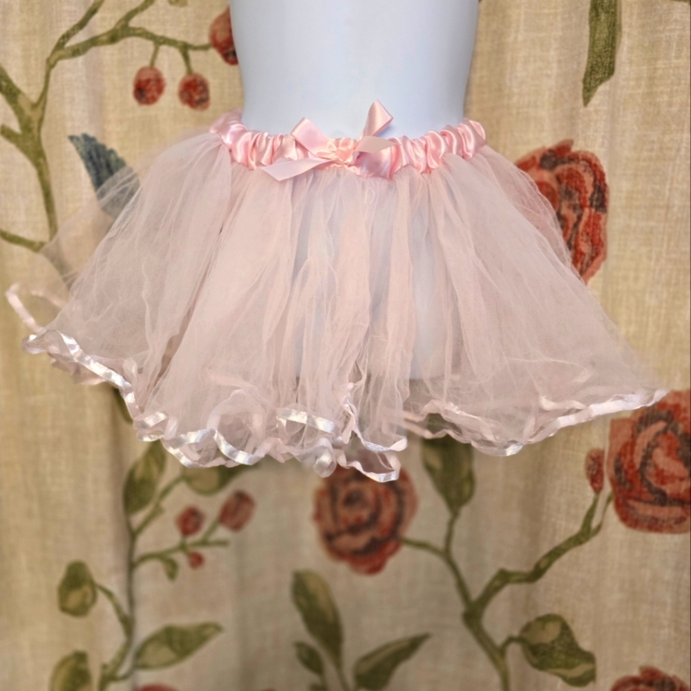 Pretty light pink tutu, adjustable in size, ribboned satin tie in the back